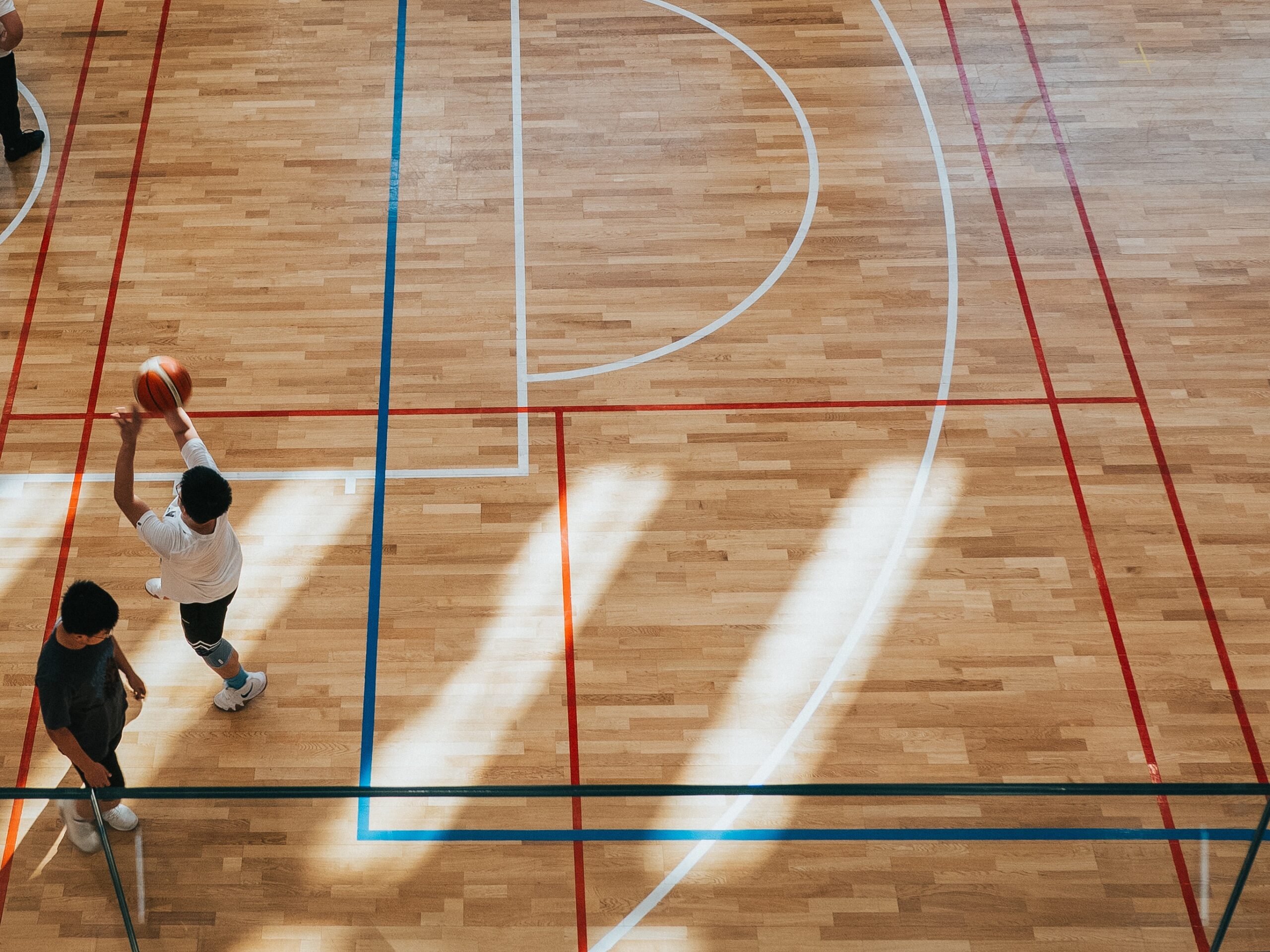 10 Key Benefits of 3on3 Basketball for Kids. Boys shooting hoops on a basketball court. PNW 3on3